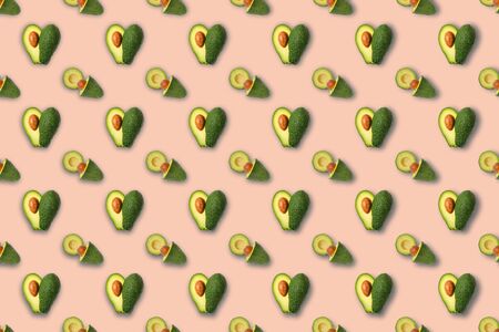 Trendy seamless sunlight Summer pattern made with avocado fruit on bright lcolorful background. Minimal summer concept.の写真素材