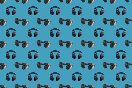 Wireless black headphones on colorful background. Square pattern for different design purposes, seamless flat layの写真素材