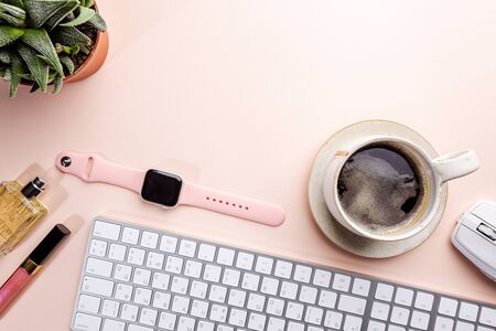 Flat lay or top view office table desk. Workspace with blank, keyboard, pen, green plant succulent,...