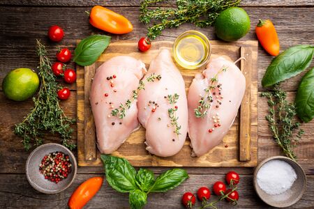Fresh raw chicken breast with herbs and spices, top view. Culinary cooking ingredientsの写真素材
