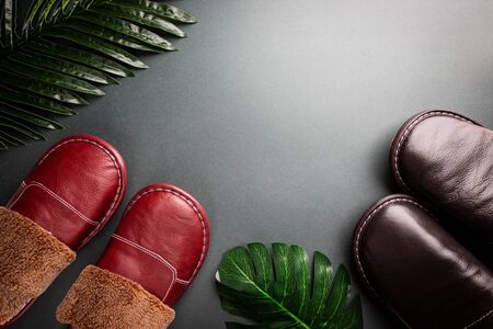 Leather home slippers on black background. Soft comfortable home slipper. Stay at home concepts.の写真素材