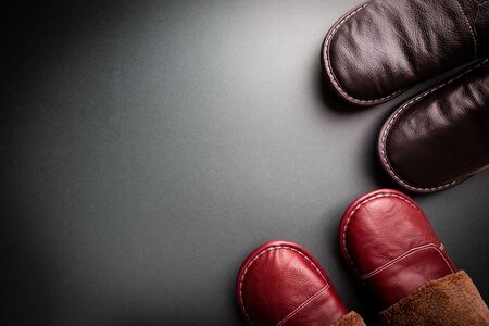 Leather home slippers on black background. Soft comfortable home slipper. Stay at home concepts.の写真素材