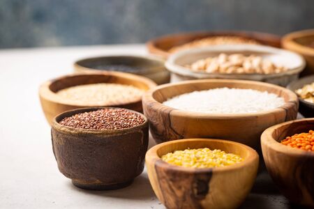 Organic products. Bowls with different gluten free grains on white backgroundの写真素材
