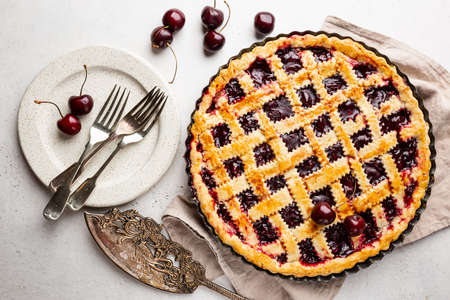 Delicious homemade classic cherry pie with a flaky crust on white background, top viewの写真素材