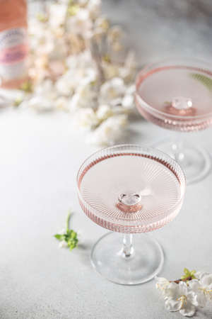 Homemade pink vodka cosmopolitan cocktail drink in crystal glassesの写真素材