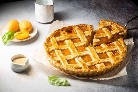 Summer homemade apricot or peach pie on white background. Delicious fruit dessert. Fruit cake.