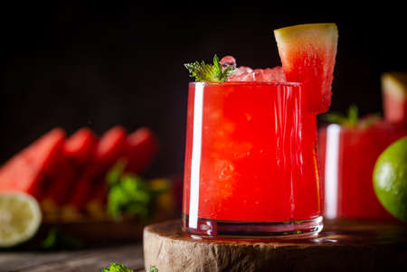Refreshing cold summer watermelon drink in glasses with slices of watermelon and limeの写真素材