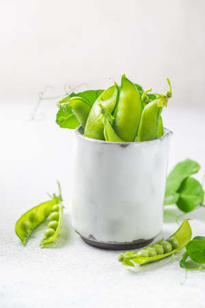 Pods of green peas on a white background close up, soft focusの写真素材