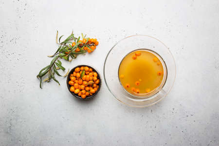 Tea with sea buckthorn on white stone background. top viewの写真素材