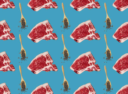 Beef steaks and t-bone meat cuts seamless on colorful blue background. Pattern background.の写真素材