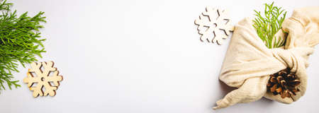 Zero waste gift wrapping traditional Japanese furoshiki style. Plastic free hand made gift package for Christmas with christmas decorations, top viewの写真素材