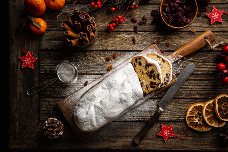 Christmas Stollen. Traditional Sweet Fruit Loaf with Icing Sugar. Xmas holiday table setting, top...