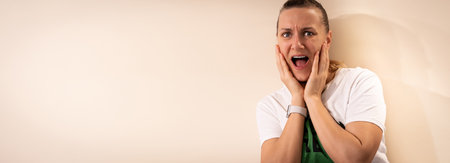 Portrait of woman with shocked facial expression isolated on light backgroundの写真素材