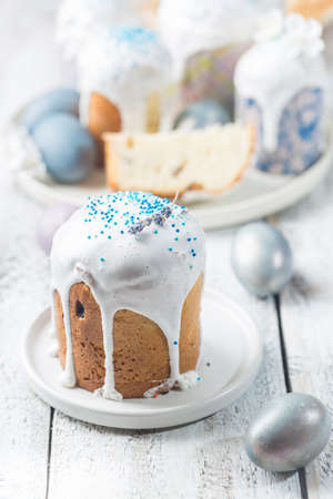 Easter table with Easter cakes and Easter eggs over white background