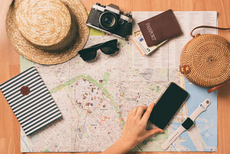 Top view travel concept with retro camera films, map and passport on wooden background with copy...