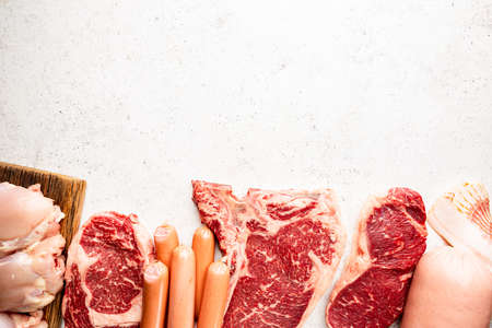 Variety of Fresh Raw meat and sausages on white background. Top view with space for your textの写真素材