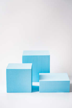 Cosmetics product advertising stand. Exhibition blue podium with geometric shapes on a white color...
