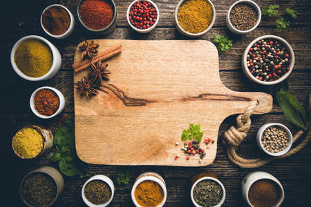 Herbs and spices in bowels over wooden background. Top view with copy spaceの写真素材
