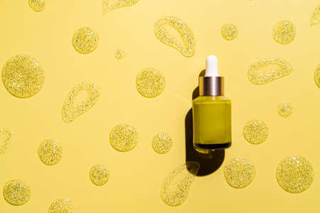 natural cosmetics for face care serum bottle on yellow background, top viewの写真素材