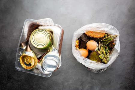 Organic food wastes in a bucket, shot from above. Zero waste, recycle, waste sorting concept - top view of peels and leftovers of fruit and vegetablesの写真素材