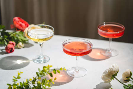 Sparkling wine or champagne glasses on white background with sharp shadows. Modern, stylish color...