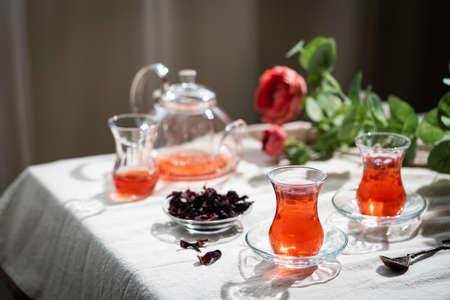 Hot red karkade tea in a glasses on rustic backgroundの写真素材