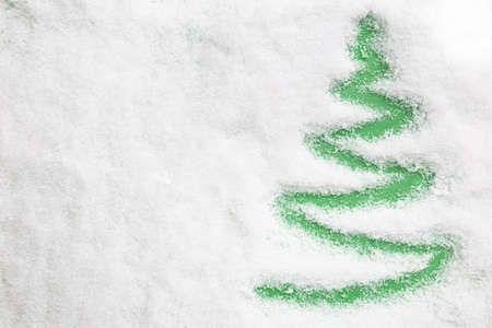 Christmas tree on snow background. Christmas concept. Flat lay, top view.の写真素材