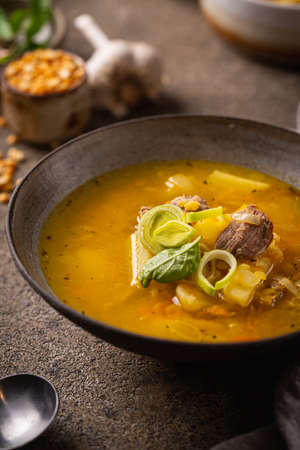 Closeup of a bowl of split pea soup with chunks of ham and meatの写真素材