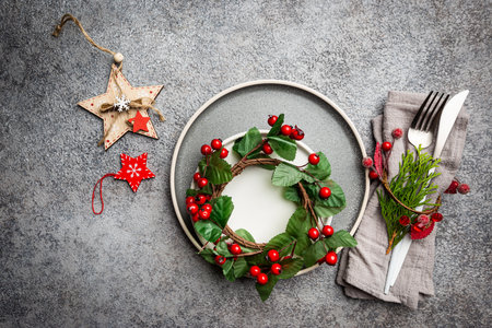 Christmas table setting with christmas decorations on gray background. Top view, copyspace.の写真素材