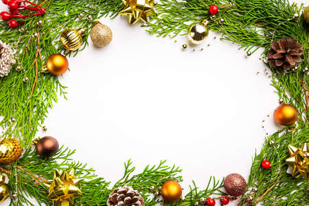 Winter and christmas wreath with gold christmas toys on white background.