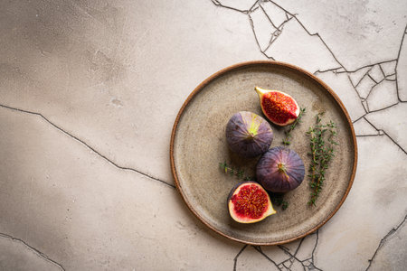 fresh figs on plate on gray stone background, top viewの写真素材