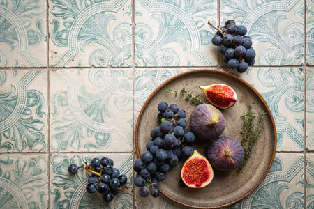 fresh figs on plate on tile background, top viewの写真素材