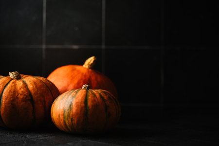 Colorful halloween pumpkins on dark background Autumn decorの写真素材