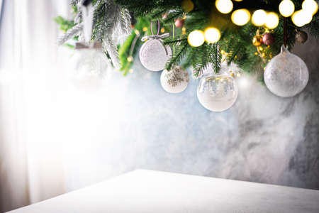 Christmas decoration with white christmas balls and fir tree branches against blurred blue background, copy space for your product or text.の写真素材