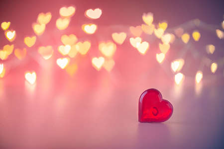 The red Heart shapes on abstract light pink glitter background. Love concept for valentines day.の写真素材