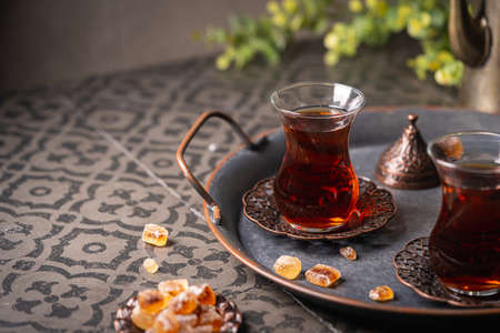 Turkish tea in traditional glass closeup on tile background