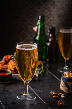 Glass of light beer on dark background. Selective focusの写真素材