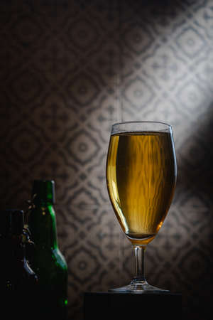 Glass of light beer on dark background. Selective focusの写真素材