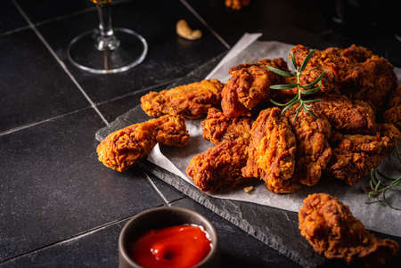 Buffalo style chicken wings served with cold beer on dark backgroundの写真素材