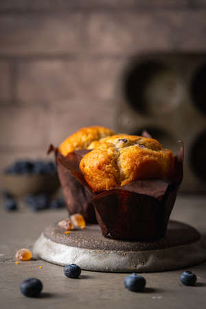 Sweet homemade pastries muffin with blueberries and fresh berries on stone background.の写真素材