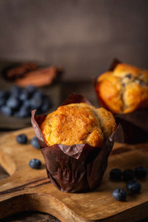 Sweet homemade pastries muffin with blueberries and fresh berries on wooden background.の写真素材