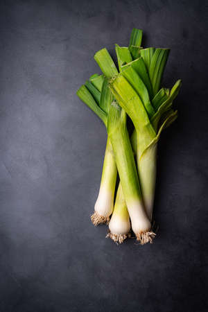Farm fresh organic leek on dark background, top viewの写真素材