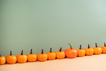 Decorative pumpkins on light orangeの写真素材