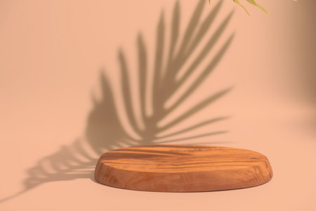 Wooden podium with leaves shadows. Realistic wood platform on peach color background for product presentation. Minimal nature scene with pedestal mockup. cosmetic display or award ceremonyの写真素材