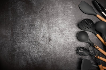 Kitchen silicone utensils for cooking tools on concrete background, top view, flat lay. Kitchenware...