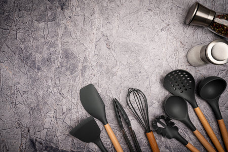 Kitchen silicone utensils for cooking tools on concrete background, top view, flat lay. Kitchenware collection with copy space. Cooking background.の写真素材