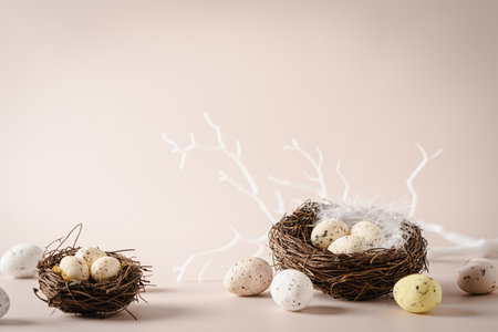Easter eggs in nests on empty beige background. minimalist backgroundの写真素材
