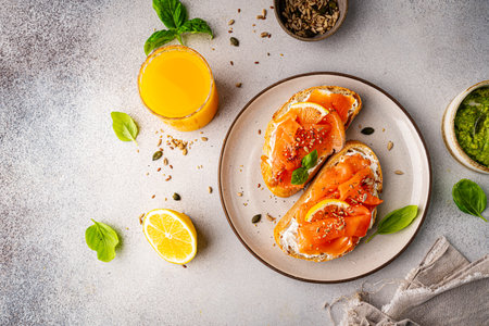 Sandwich with ricotta (cream cheese), smoked salmon and micro greens served on white background. Health care, super food concept. . Top view.の写真素材