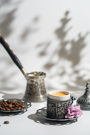 Coffee in metal Turkish traditional cup and coffee beans on white background with shadowsの写真素材