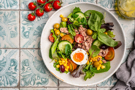 Tuna salad with tomatoes , olives , eggs and onion .の写真素材